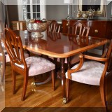 F20. Baker Furniture Historic Charleston banded double pedestal dining table with six chairs. 29”h x 70”wx 46”d (includes 3 18” leaves and custom pads) 